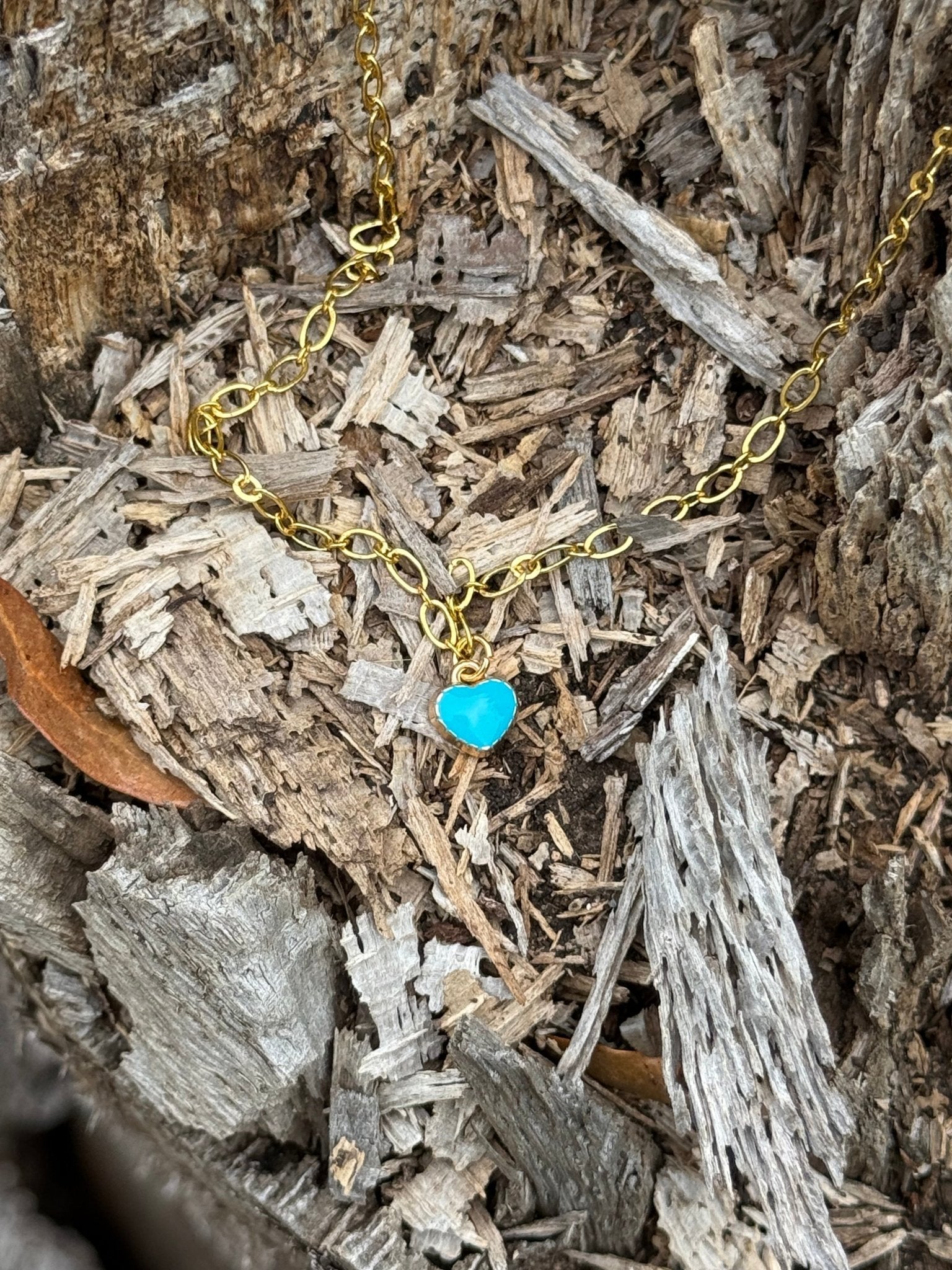 Turquoise heart pendant gold chain necklace by Wild Junkie featuring a vibrant turquoise heart charm on a delicate gold chain.