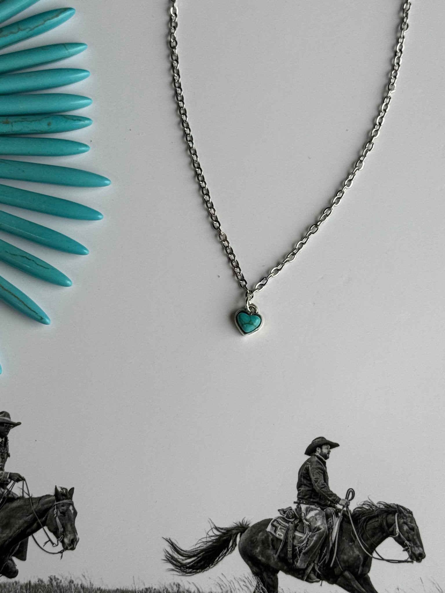 Turquoise heart pendant gold chain necklace by Wild Junkie featuring a delicate chain and vibrant turquoise heart charm.