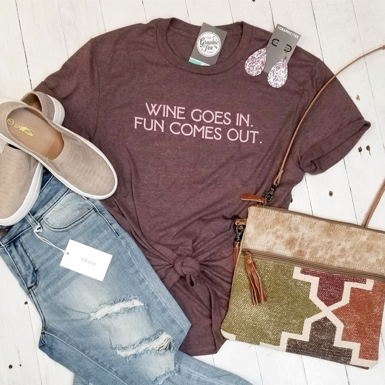 Adult SS graphic tee featuring humorous "Wine Goes In. Fun Comes Out." design by The Graphic Tee, casual wear for wine lovers.