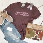 Adult SS graphic tee featuring humorous "Wine Goes In. Fun Comes Out." design by The Graphic Tee, casual wear for wine lovers.