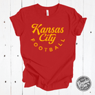 Youth Kansas City football short sleeve tee by The Graphic Tee, featuring red and gold team colors and graphic design.