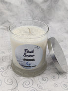 Practical Magic Store First Snow Candle with white wax and simple glass jar, perfect for cozy winter ambiance.