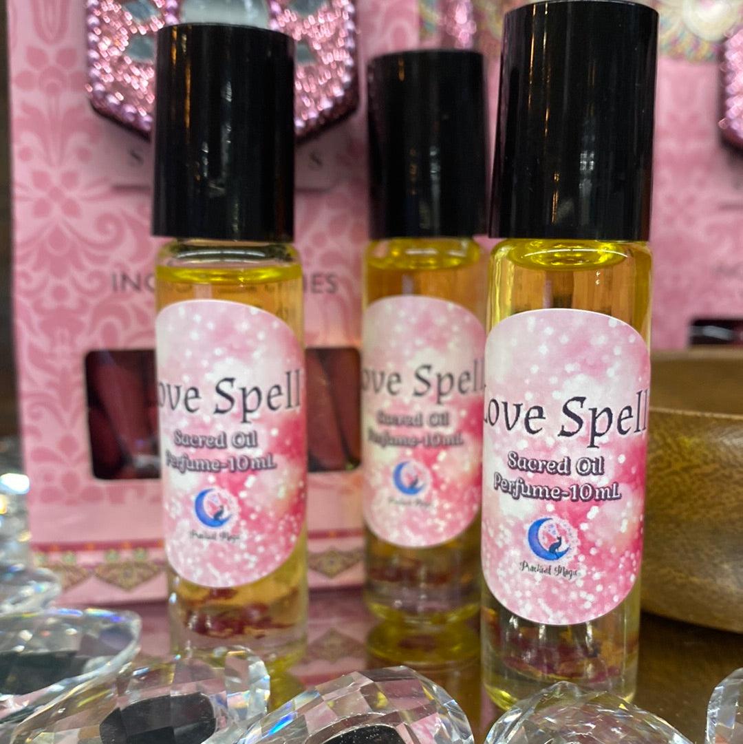 Practical Magic Store Love Spell Oil Perfume bottle with decorative label and cap, displayed on a neutral background.