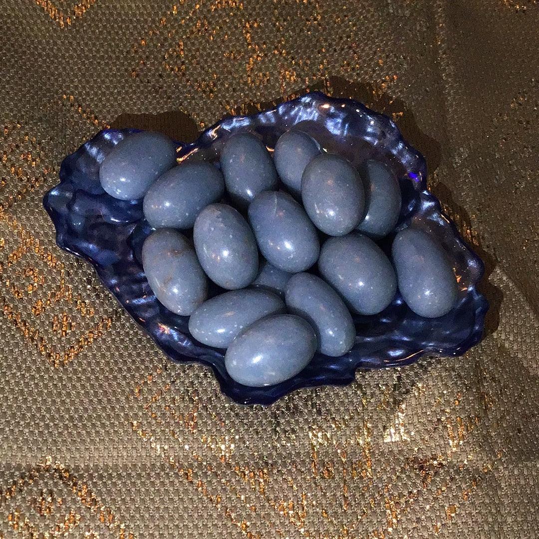 Large Angelite tumbled stones from Practical Magic Store, showcasing smooth, pale blue mineral stones for healing and meditation.